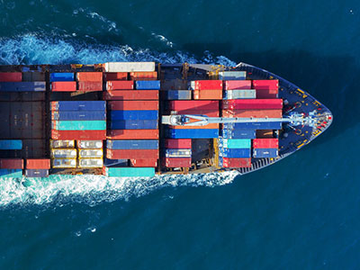 aerial view of barge in the ocean with shipping containers - Tungsten Network Supply Chain